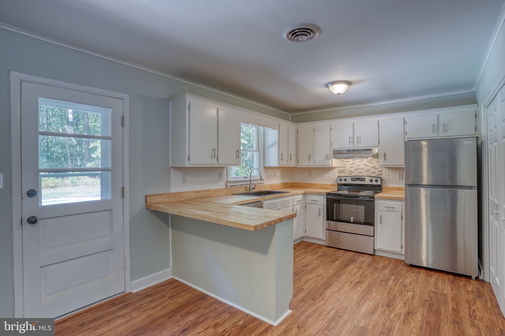 4570 Evergreen Road Oxford, MD 21654 - Photo 14 of 27 a kitchen with a sink stove and refrigerator