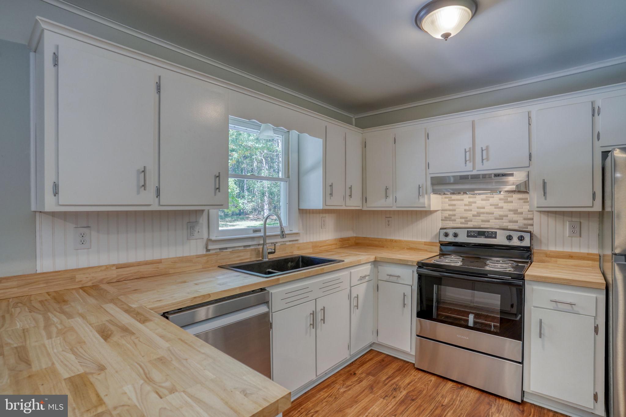 4570 Evergreen Road Oxford, MD 21654 - Photo 15 of 27 a kitchen with cabinets appliances a sink and a window