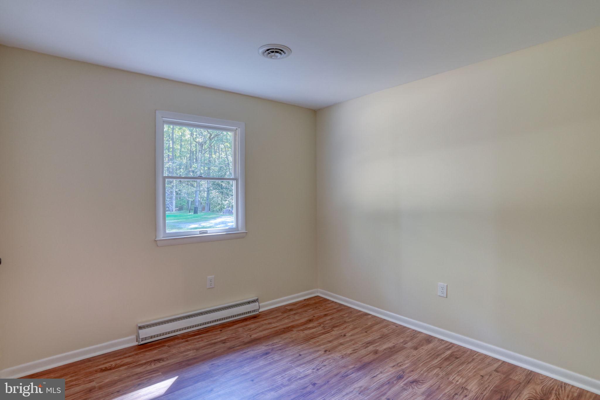 4570 Evergreen Road Oxford, MD 21654 - Photo 20 of 27 an empty room with wooden floor and windows