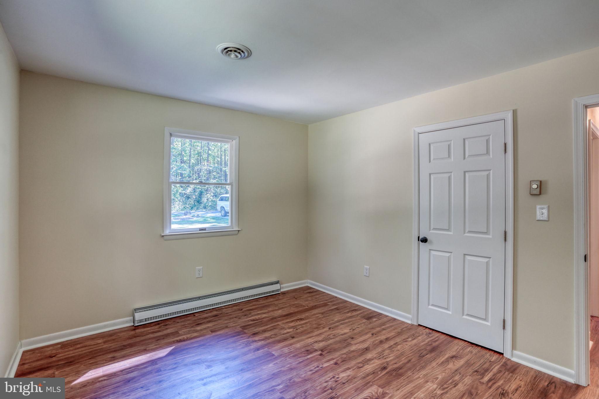 4570 Evergreen Road Oxford, MD 21654 - Photo 21 of 27 an empty room with wooden floor and windows
