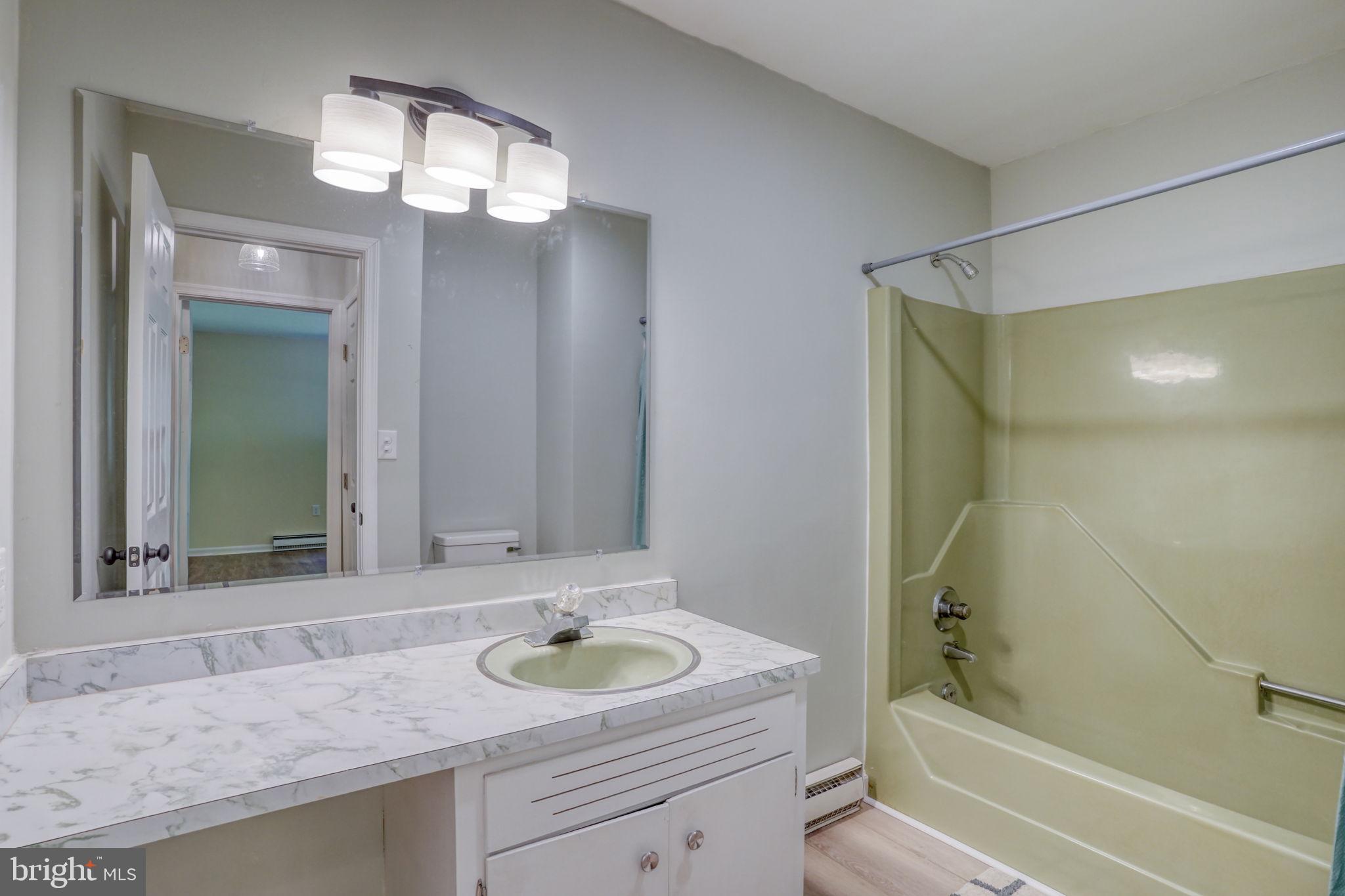 4570 Evergreen Road Oxford, MD 21654 - Photo 22 of 27 a bathroom with a sink and a mirror