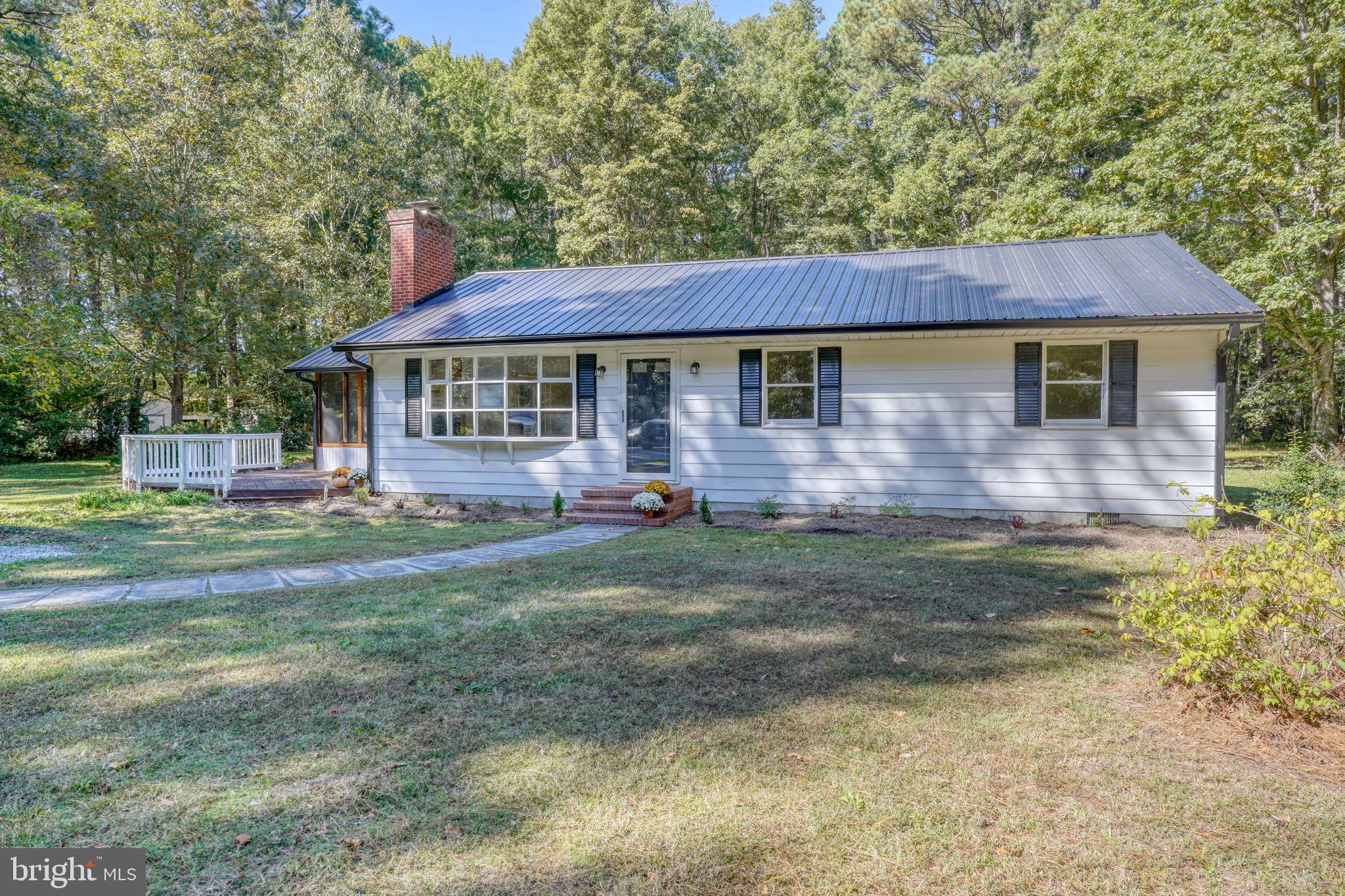 4570 Evergreen Road Oxford, MD 21654 - Photo 3 of 27 a front view of a house with a yard