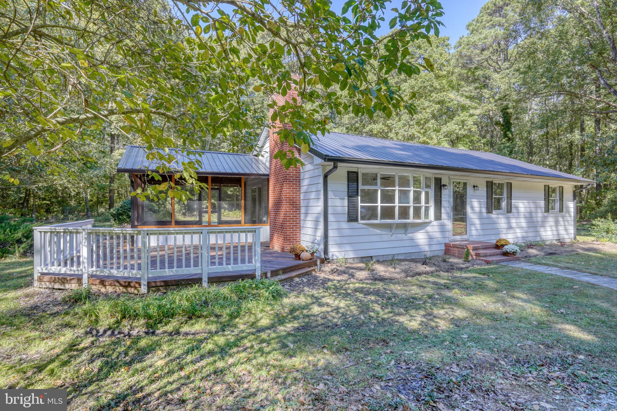 4570 Evergreen Road Oxford, MD 21654 - Photo 4 of 27 a view of a house with a yard and deck