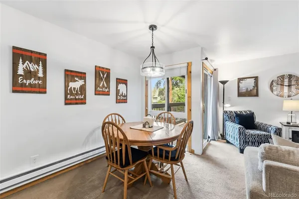 a dining room with furniture a window and a chandelier