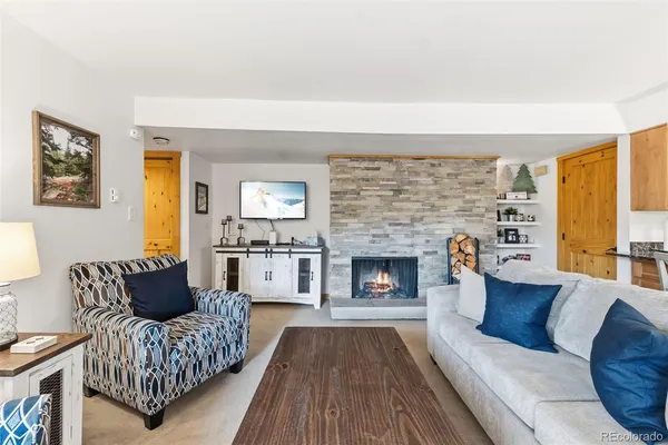 a living room with furniture and a fireplace