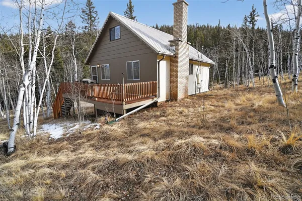 a view of a house with a yard and wooden fence