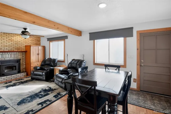 a living room with furniture a fireplace and a table