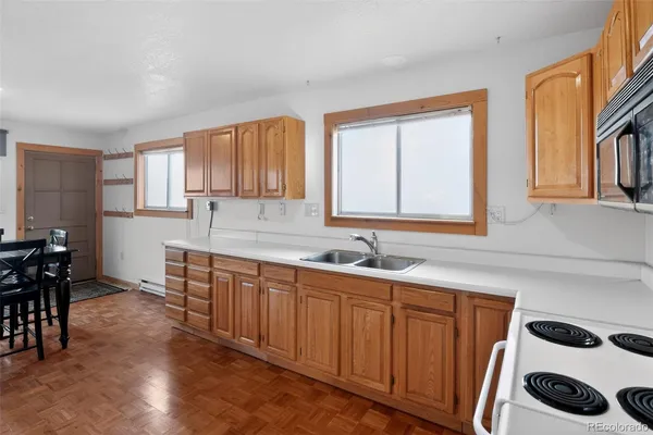 a kitchen with a sink a window and cabinets