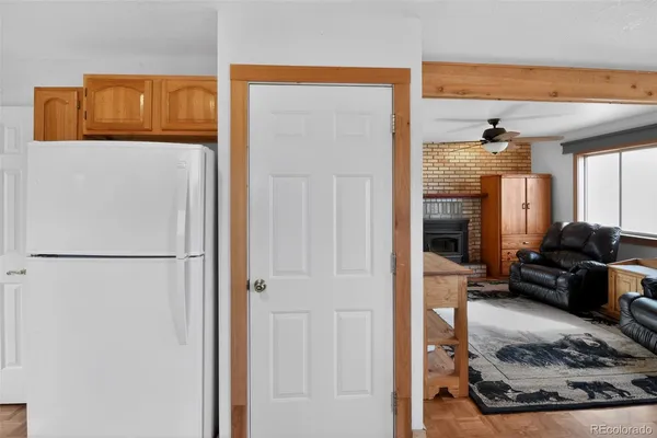 a view of a hallway with a refrigerator and a window