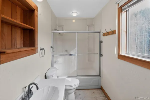 a bathroom with a sink toilet and shower