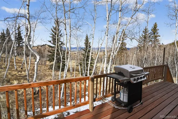 a view of a balcony with wooden floor and fence