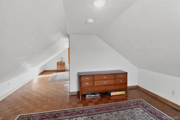 a view of a room with wooden floor and window