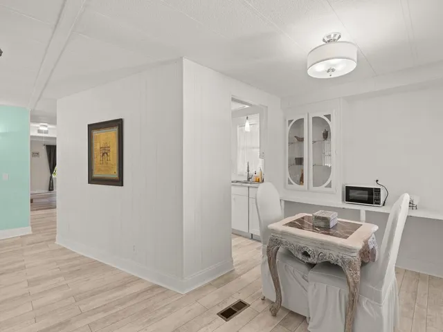 a view of a workspace with furniture and wooden floor