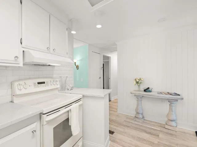 a kitchen with a stove a sink and a refrigerator