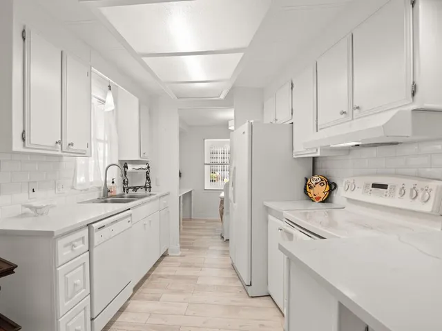 a kitchen with a sink a stove and refrigerator