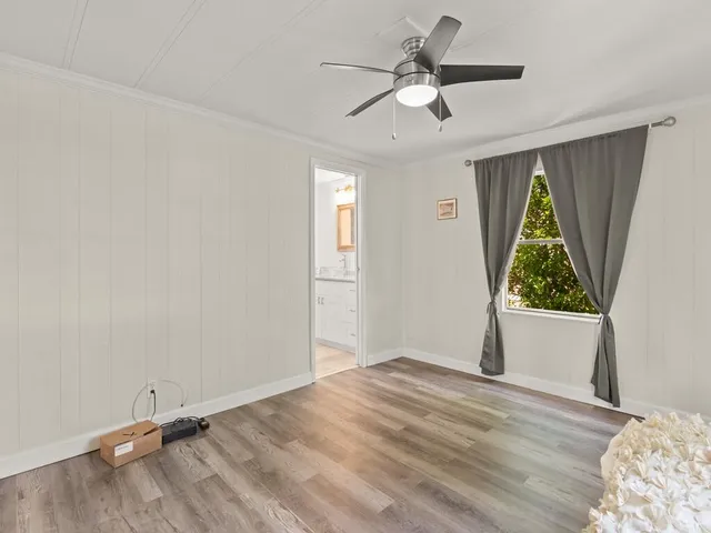 a view of room with window and ceiling fan