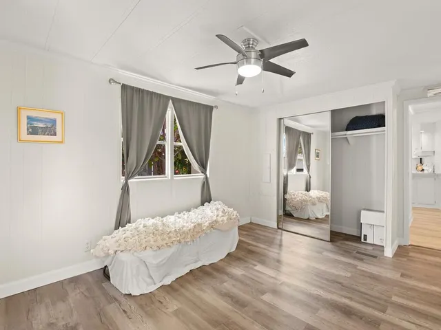 a living room with a bed furniture and a window