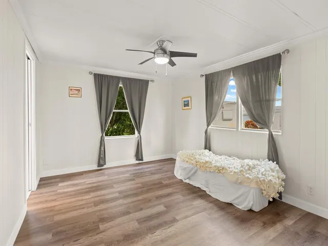 a bedroom with a bed and a large window