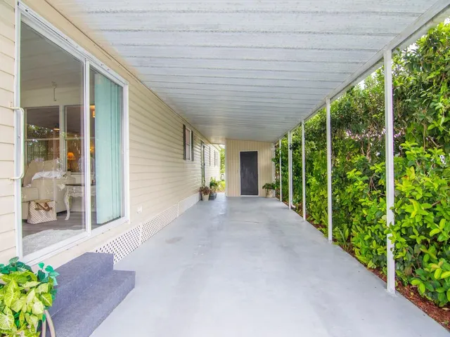 a view of a house with porch and garden