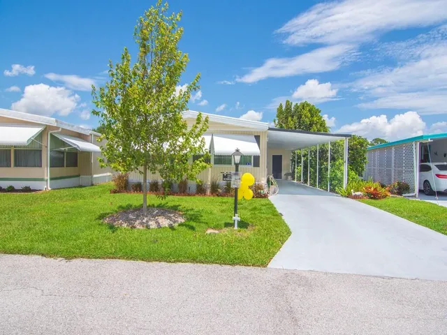 a front view of a house with a garden and plants