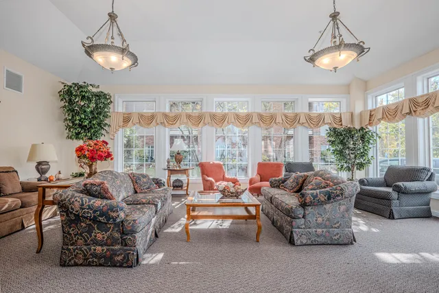 a living room with furniture and a chandelier