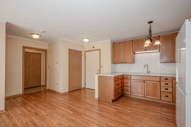 a kitchen with stainless steel appliances granite countertop a sink cabinets and wooden floor