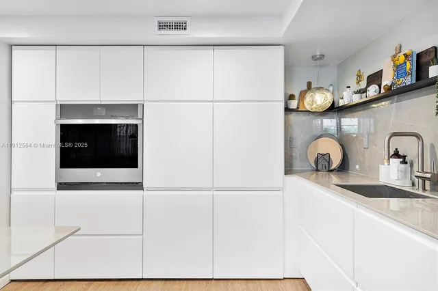 a kitchen with a sink and a refrigerator