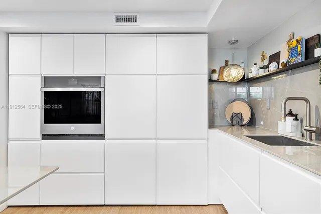 a kitchen with a table chairs refrigerator and microwave