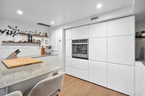 a view of kitchen with cabinets and wooden floor