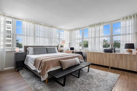 a bedroom with a large bed and a large window