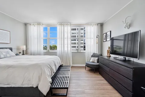 a bedroom with a bed and a lamp