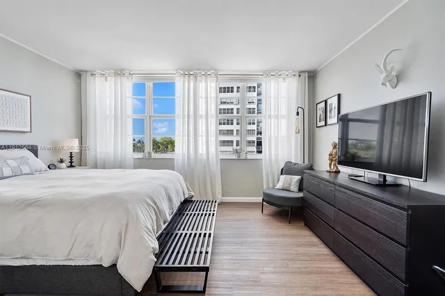 a bedroom with a bed and a lamp