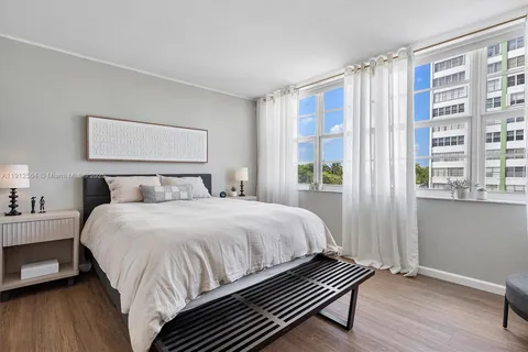 a bedroom with a bed and a television