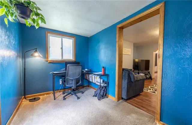 a view of a workspace with furniture and a workspace