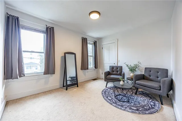 a living room with furniture chess and a window