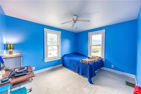 a bed room with a bed and a window