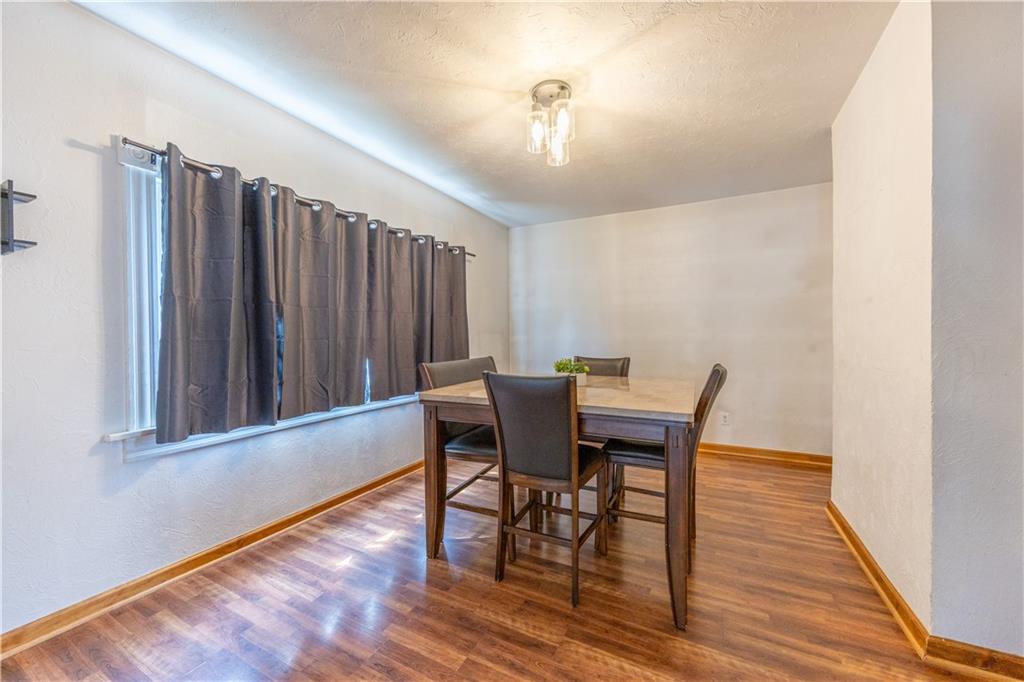 201 Walters Lane Springdale, PA 15144 - Photo 9 of 24 a view of a dining room with furniture and wooden floor