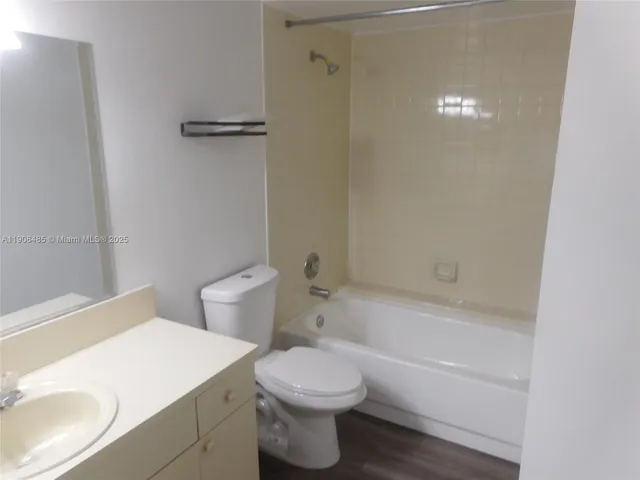 a bathroom with a granite countertop toilet a sink and bathtub
