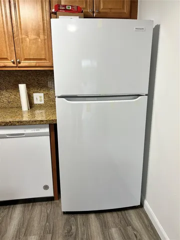 a view of a refrigerator in kitchen