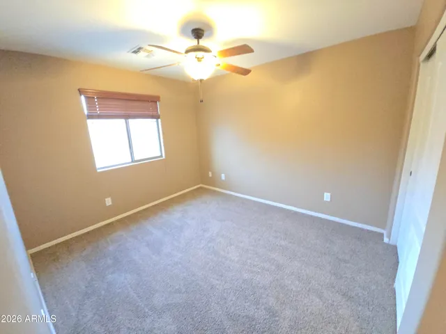 a view of a kitchen with a sink and a refrigerator