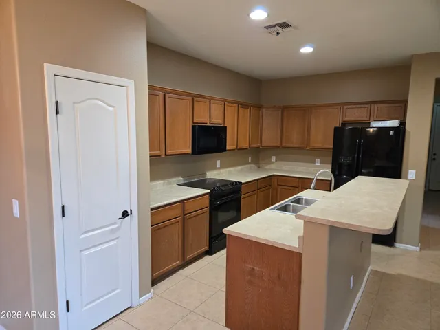 a kitchen with granite countertop a sink and a stove