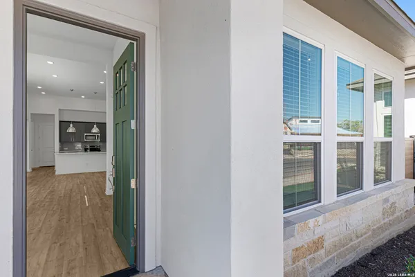 a view of a hallway with dining room and wooden floor