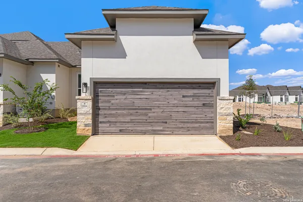 a view of a house with a yard and garage