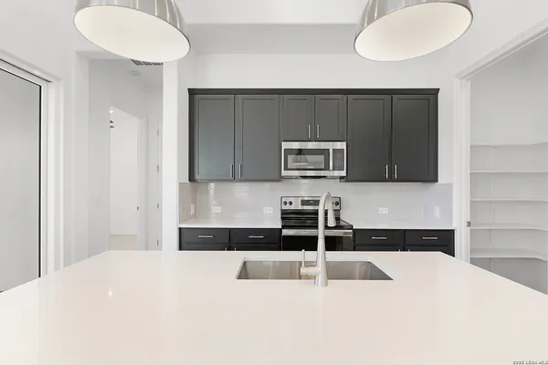 a kitchen with a refrigerator and a sink