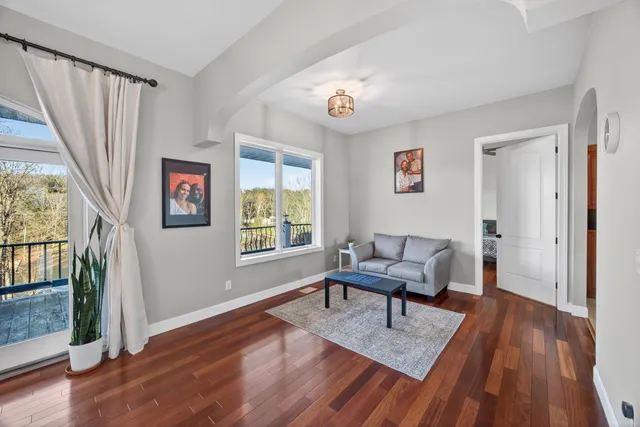 a living room with furniture fireplace and wooden floor