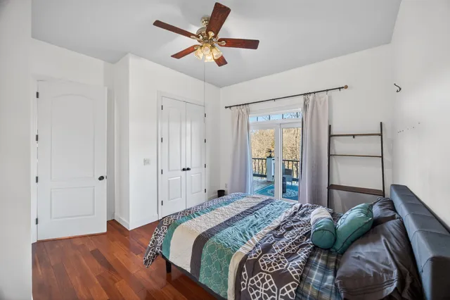 a bedroom with a large bed and a chandelier