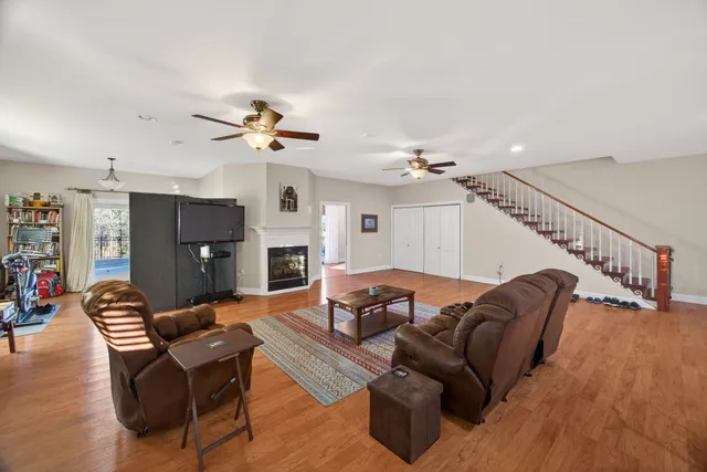 a view of a room with furniture wooden floor and a chandelier