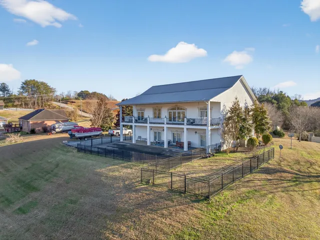 a view of a house with swimming pool and sitting area