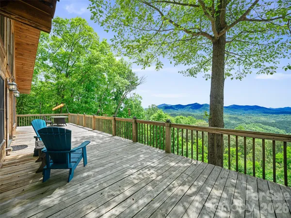 a view of a balcony with wooden floor and bench