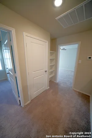 an empty room with an entrance to other room